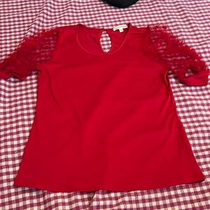 Selling a red shirt by above and beyond the size is a large